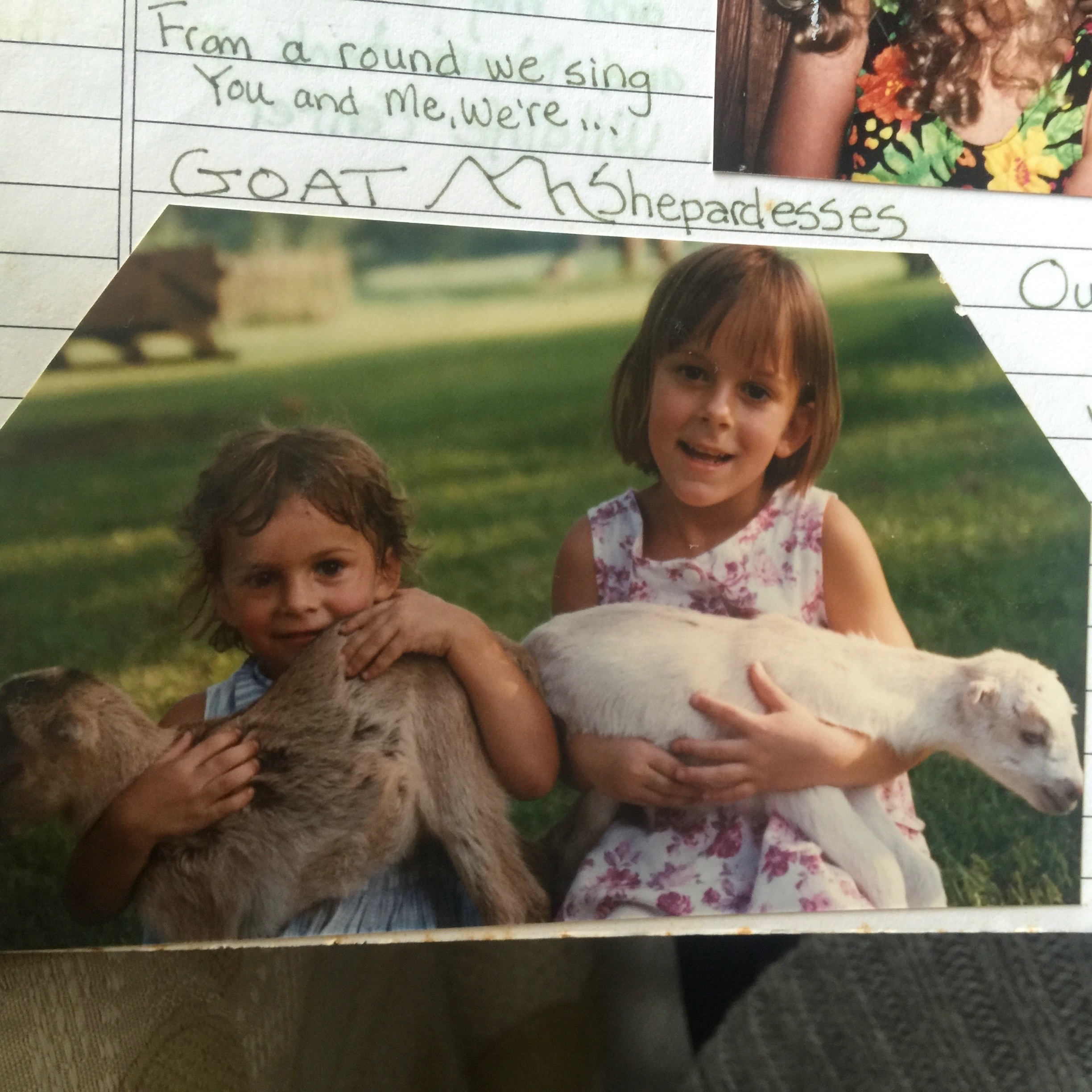 Anna and Abigail as little girls, holding baby goats